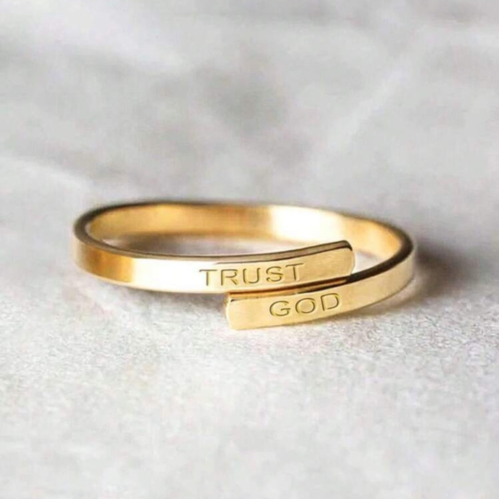 - ring engraved with 'Trust' and 'God'